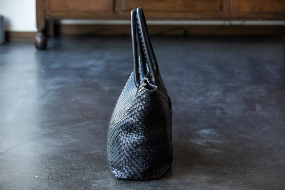 A large tote bag with a striking leather sheen