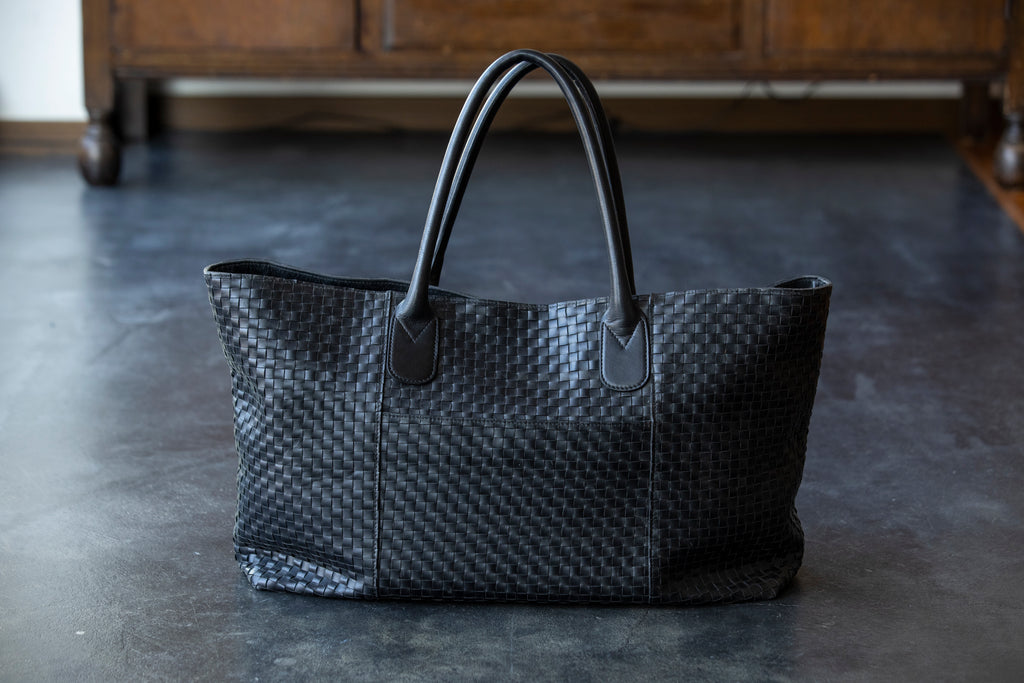A large tote bag with a striking leather sheen