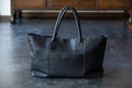 A large tote bag with a striking leather sheen