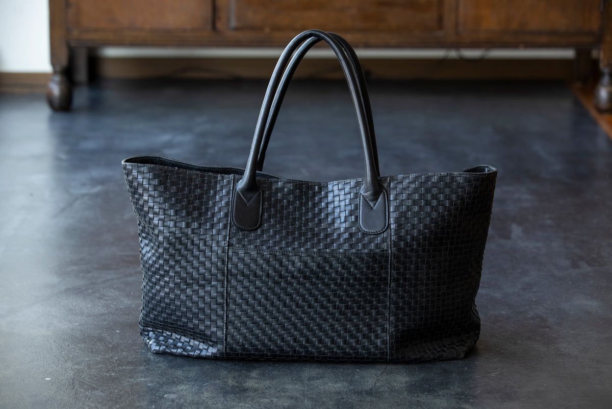 A large tote bag with a striking leather sheen
