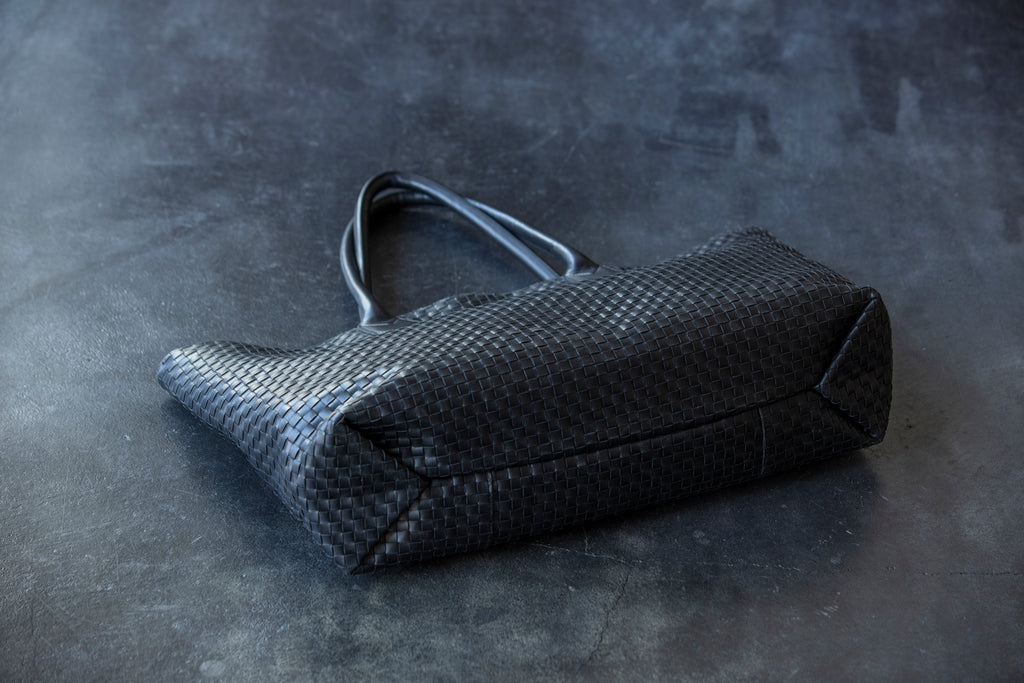 A large tote bag with a striking leather sheen
