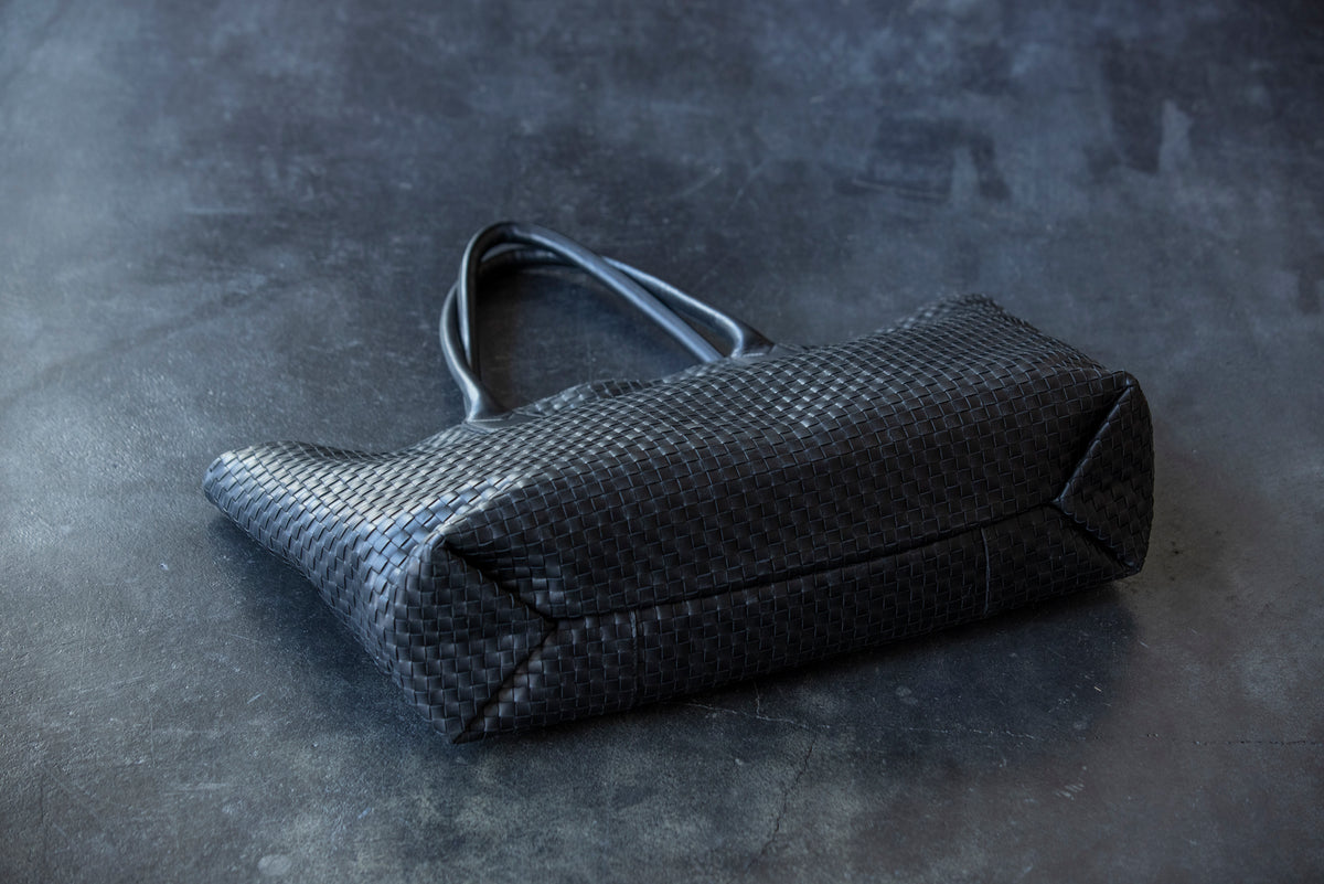 A large tote bag with a striking leather sheen